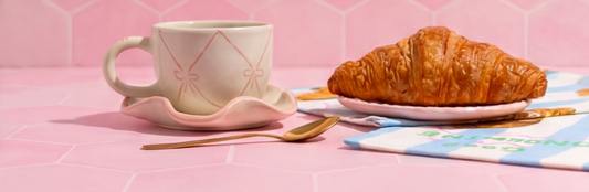 Delicate pink bow ceramic cup saucer close-up – handmade pottery by Pankhhari