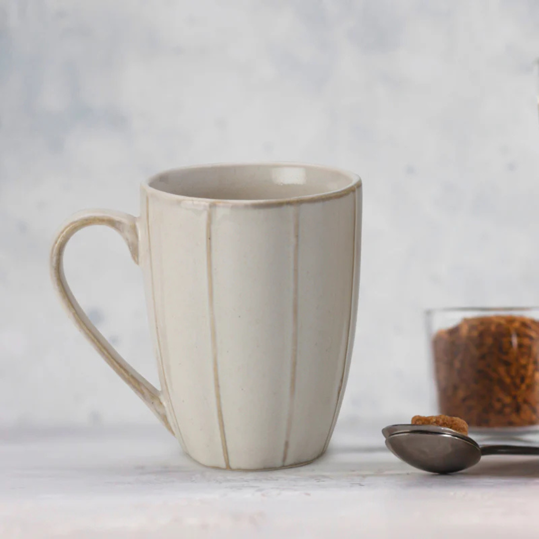 Elegant off-white 300ml porcelain coffee mug on a wooden surface – minimalist mug by Pankhhari India